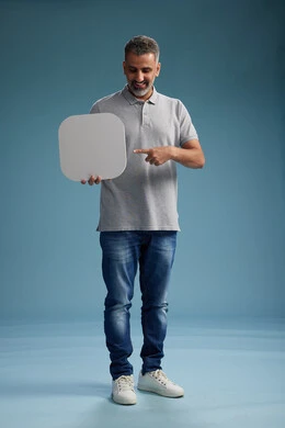 A Saudi Arabian Gulf Arab man wearing casual attire holding a white square board, a marketing advertisement display, with various movements and gestures, against a blue background, full body.