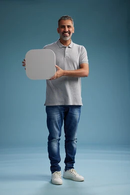 A Saudi Arabian Gulf Arab man wearing casual attire holding a white square board, a marketing advertisement display, with various movements and gestures, against a blue background, full body.