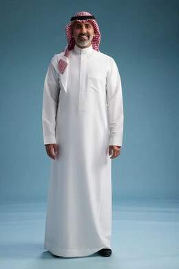 A portrait of a confident Arab Saudi Gulf man wearing a white thobe and a shemagh, smiling, with various gestures and movements, against a blue background.
