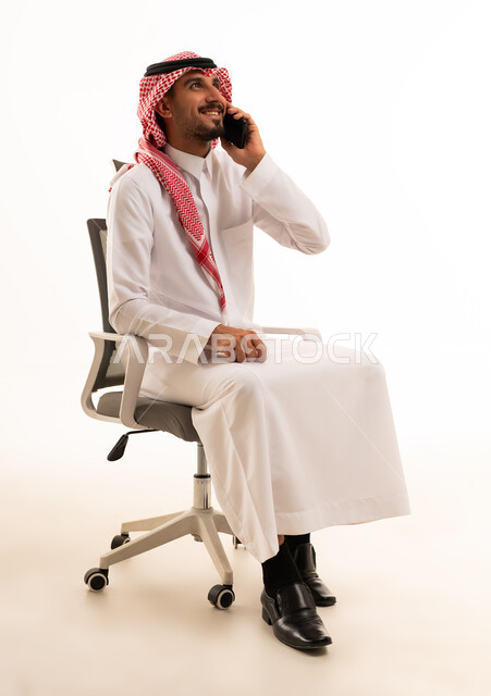Saudi Man Talking on Smartphone in Office Chair
