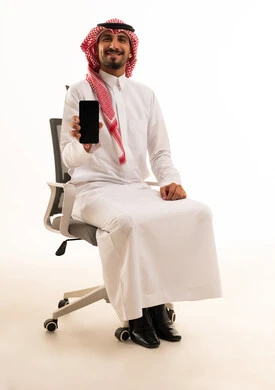 Saudi Man Holding Smartphone in Office Chair