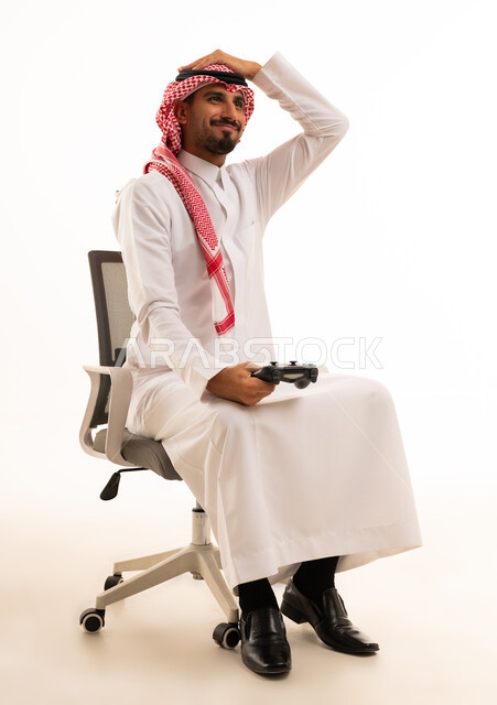 Saudi Man in Traditional Thobe Holding Gaming Controller