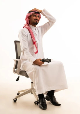 Saudi Man in Traditional Thobe Holding Gaming Controller