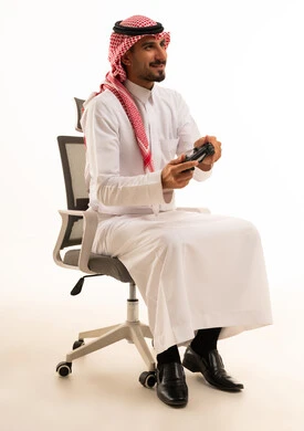 Saudi Man Playing Video Games in Traditional Dress