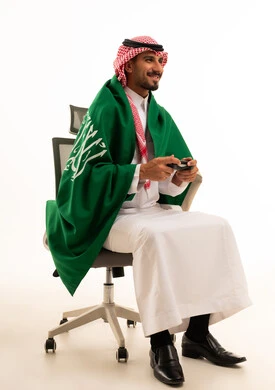 Saudi Man Holding Game Controller with National Flag