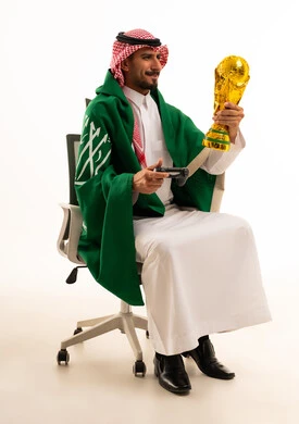 Saudi Man Holding World Cup Trophy and Game Controller