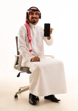 Saudi Man Holding Smartphone Wearing Headphones