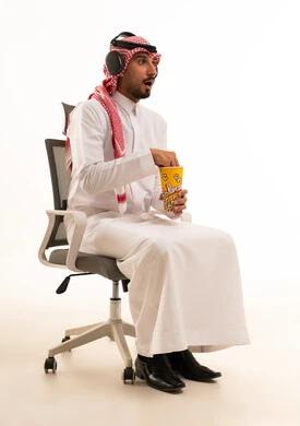 Shocked Saudi Man with Popcorn and Headphones
