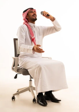 Saudi Man Singing with Microphone on White Background