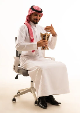 Saudi Man with Incense Burner on Office Chair