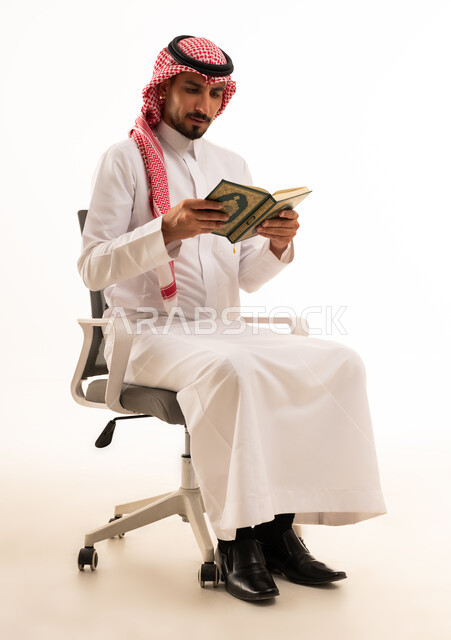 Saudi Man Reading Holy Quran in Traditional Thobe