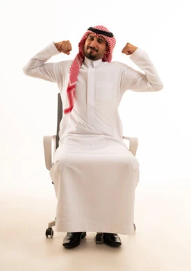 رجل سعودي يستعرض عضلاته على كرسي مكتب