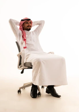 Saudi Man in Traditional Dress Relaxing in Office Chair