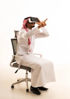 Saudi Man Using VR Headset in Office Chair