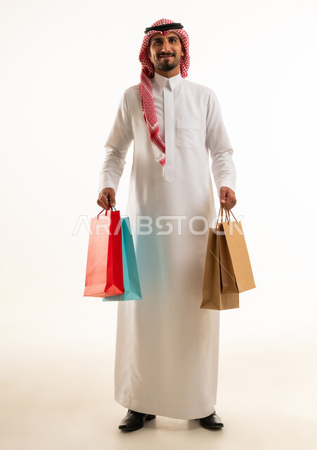 Saudi Man Holding Shopping Bags in Studio