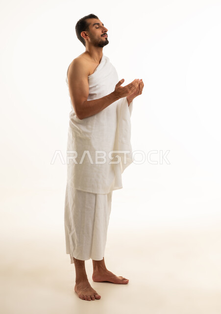 Saudi Man in White Ihram Prayer Pose Studio Shot