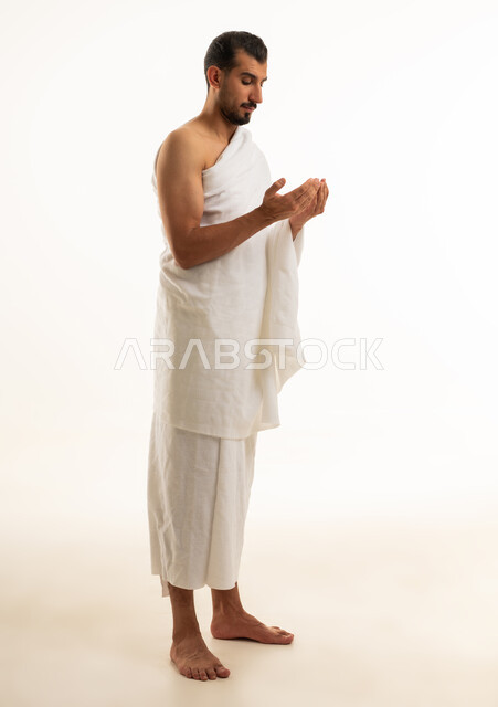 Muslim Man in Ihram Praying on White Background