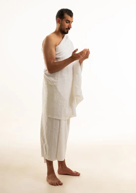 Muslim Man in Ihram Praying on White Background