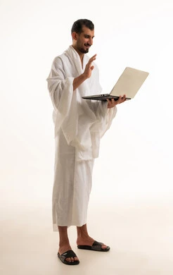 Saudi Man in Ihram Using Laptop for Video Call