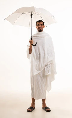 Saudi Man in Ihram Holding White Umbrella