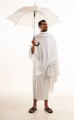 Saudi Man in White Ihram Holding Umbrella