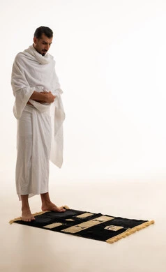 Saudi Man in Ihram Standing on Prayer Rug