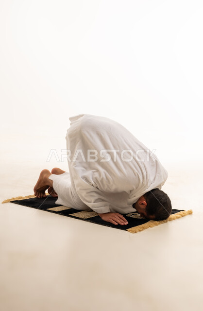 Muslim Man Prostrating in Prayer on White Background