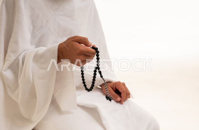 Muslim Pilgrim in Ihram Holding Prayer Beads