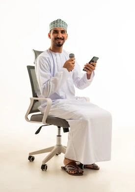 Omani Man with Microphone and Smartphone in Office Chair