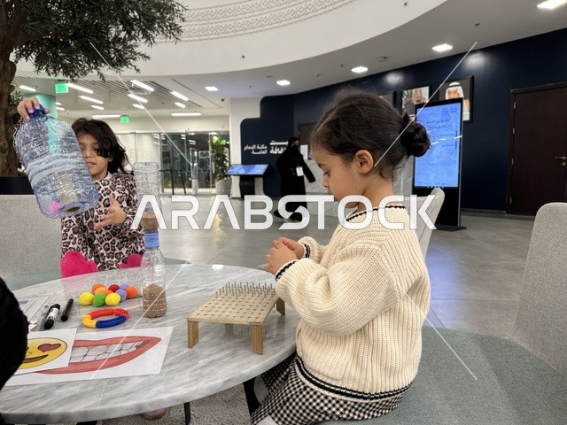 An interactive activity and student participation on World Education Day at the Culture Library, Dammam Public Library, Kingdom of Saudi Arabia, on January 30, 2026. An educational and cultural event that highlights the importance of education and its role in building communities, with knowledge activities and educational workshops, creating an inspiring cultural environment that celebrates science and knowledge and supports sustainable learning.