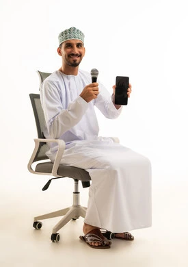 Omani Man Holding Microphone and Smartphone in Studio