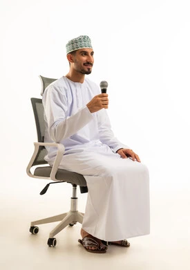 Omani Man with Microphone Sitting on Office Chair
