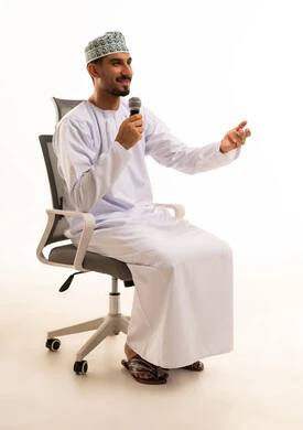 Omani Man Speaking into Microphone in Traditional Dress