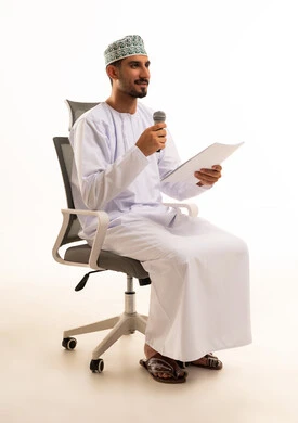 Omani Man with Microphone Giving a Presentation