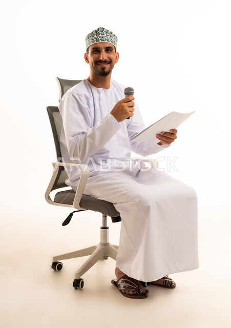 Omani Man with Microphone Sitting in Office Chair