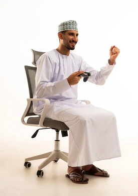 Omani Man Celebrating Video Game Victory in Dishdasha