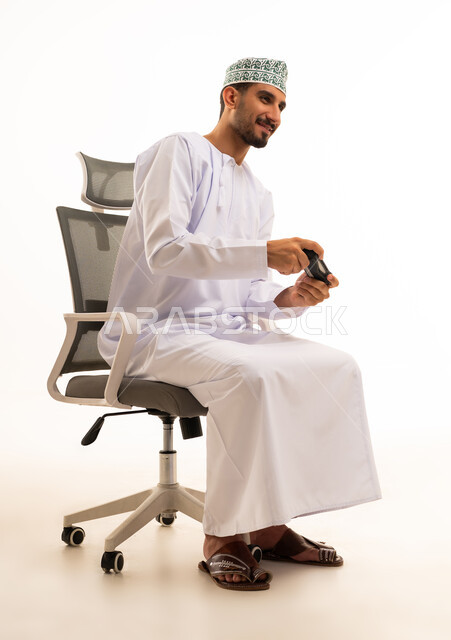 Omani Man Playing Video Games on Office Chair
