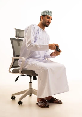 Omani Man Playing Video Games on Office Chair