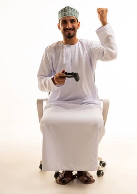 Omani Man with Game Controller Celebrating Victory