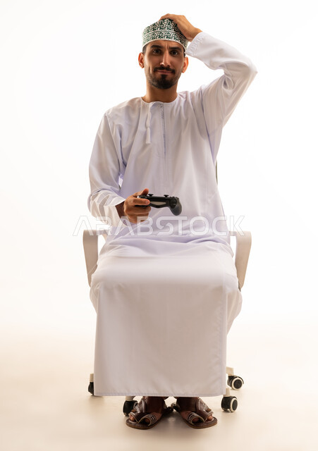 Omani Man with Gaming Controller on White Background