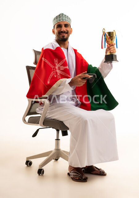 Omani Man with National Flag and Gaming Trophy