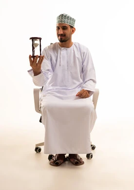 Omani Man with Hourglass in Office Chair