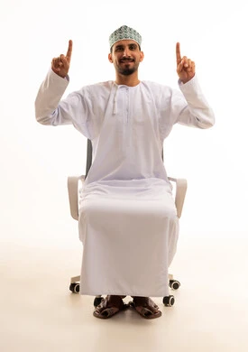 Omani Man in Traditional Dress Pointing Upward