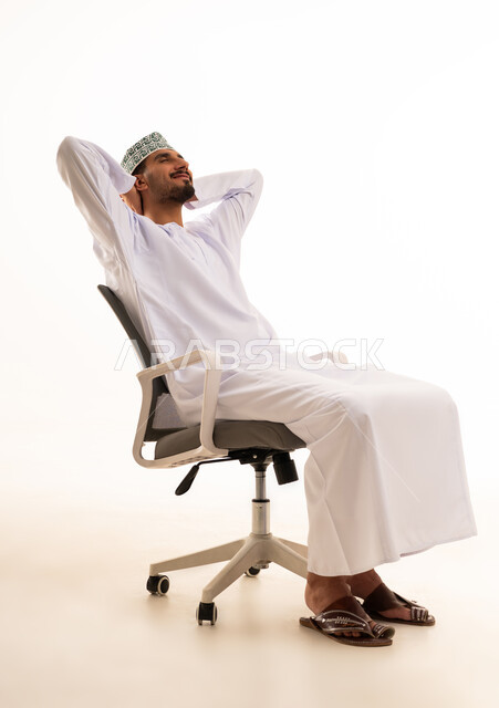 Omani Man in Traditional Dress Relaxing in Office Chair