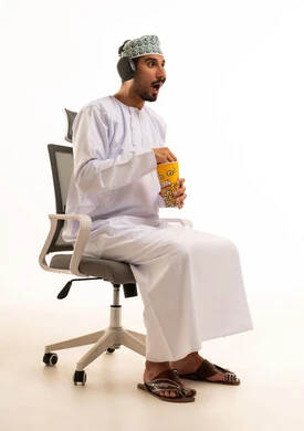 Omani Man with Popcorn and Headphones Surprised Expression