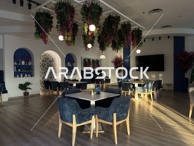 Elegant decor in one of the cafes at the Shore Mall in Dammam, Eastern Province, Saudi Arabia, a comprehensive commercial and entertainment center, featuring local and international stores and brands, diverse restaurants and cafes, recreational areas for children and families, seasonal events and marketing activities, and a family-friendly atmosphere for all age groups.