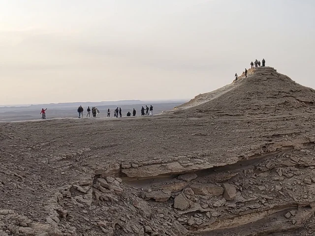 The Grand Canyon overlook, a natural view of the edge of the world, the Tuwaiq Mountains in Riyadh, mountains in Najd in the Kingdom of Saudi Arabia, desert areas, rocky mountains and elevations, rocky peaks, historical landmarks, tourism in Saudi Arabia.