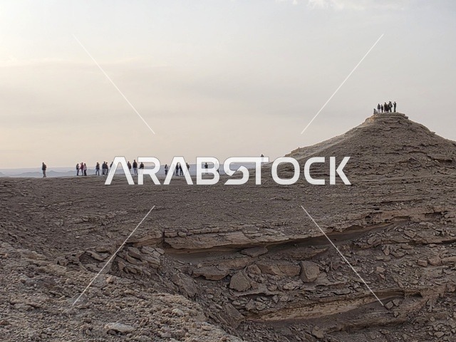 A massive mountain range, overlooking the Grand Canyon, a natural view of the edge of the world, the Tuwaiq Mountains in Riyadh, mountains in Najd in the Kingdom of Saudi Arabia, desert areas, rocky mountains and highlands, rocky peaks, historical landmarks, tourism in Saudi Arabia.