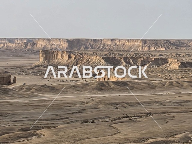 Limestone and ancient marine fossils, a natural landscape at the edge of the world, the Tuwaiq Mountains in Riyadh, mountains in Najd in the Kingdom of Saudi Arabia, desert areas, rocky mountains and highlands, rocky peaks, historical landmarks, tourism in Saudi Arabia.