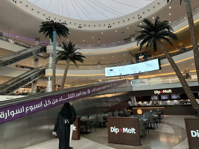 The escalator at Al-Shatea Mall in Dammam, Eastern Province, Saudi Arabia, is part of a comprehensive commercial and entertainment center, featuring local and international stores and brands, a variety of restaurants and cafes, recreational areas for children and families, seasonal events and marketing activities, and a family-friendly atmosphere for all age groups.